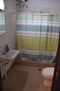 a bathroom with a shower curtain and a sink at Rios libres in Potrerillos +12 photos