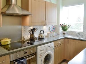 a kitchen with a washing machine and a sink at Kerloch View in Banchory