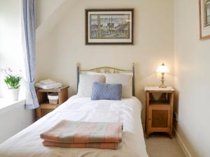a bedroom with a bed and a picture on the wall at Kerloch View in Banchory