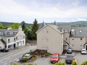 a view of a town with cars parked in a parking lot at Kerloch View in Banchory