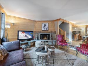 a living room with a couch and a fireplace at Chalet cosy au centre de Courchevel Le Praz avec sauna, terrasse et parking - FR-1-568-15 in Courchevel