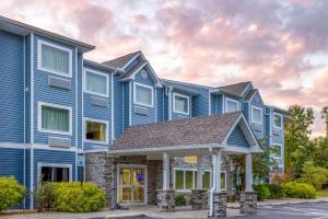 a blue apartment building with a gazebo at Microtel Inn and Suites - Salisbury in Salisbury