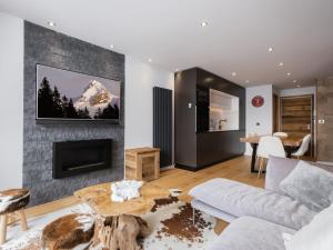 a living room with a couch and a fireplace at Appartement La Clusaz, 3 pièces, 6 personnes - FR-1-304-274 in La Clusaz