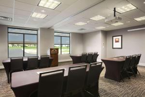 a conference room with a table and chairs at Wingate by Wyndham - Bismarck in Bismarck