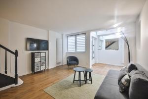 een woonkamer met een bank en een tafel bij 2.Luxueux Duplex 6/8pers/Full Equipped/République in Parijs