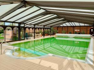 a large swimming pool with a large canopy at Field House in Baschurch
