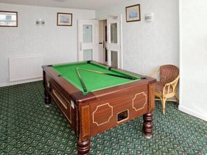 a room with a pool table in a room at St Lawrence in St Brelade