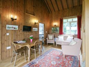 a living room with a table and chairs and a couch at The Station - E5336 in Wetheringsett