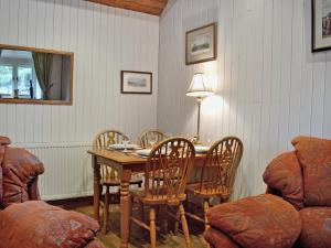 a dining room with a wooden table and chairs at Tremafon in Barmouth