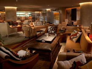 a living room filled with lots of couches and chairs at SLS Brickell in Miami