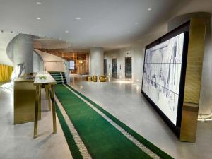 a bowling alley with a large screen in a building at DUA Miami, Autograph Collection in Miami