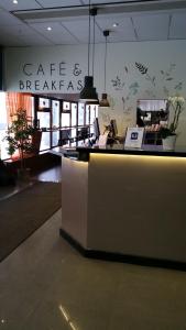 a lobby with a reception counter in a store at Hotell Centralstation in Uppsala