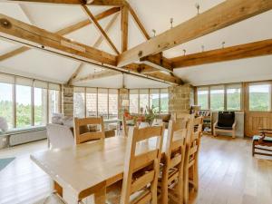 a living room with a wooden table and chairs at The Wheel House in Potto