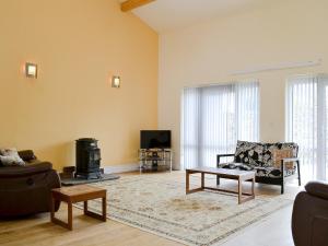 a living room with a couch and a table at Glanmwrg Barn in Trostre