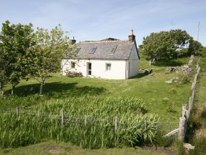 a white house on a hill with a fence at Achd in Nedd