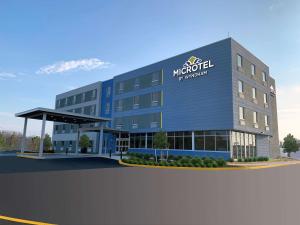 a rendering of the front of a hotel at Microtel Inn & Suites by Wyndham Rehoboth Beach in Rehoboth Beach