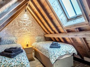 two beds in a attic bedroom with wooden ceilings at Pippin-uk41837 in Clevedon