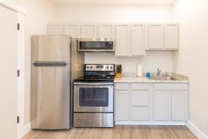 a kitchen with white cabinets and a stainless steel refrigerator at Updated 2 Bedroom Apartment in Great Falls