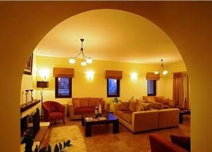 a living room with couches and a couch and a table at Guesthouse Michobeis in Kamarína