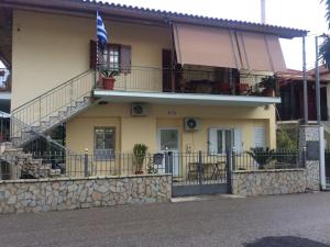 a house with a balcony and a flag on it at Maria's house in Diakopto
