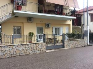 a house with a stone wall and a balcony at Maria's house in Diakopto