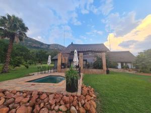 a house with a swimming pool in a yard at Mountain Villa House in Hartbeespoort