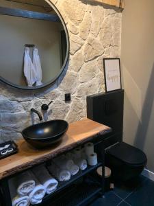 a bathroom with a sink and a mirror on a counter at Sleepzzz in Heusden