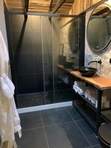 a shower with a glass door in a bathroom at Sleepzzz in Heusden