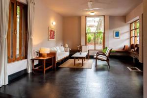 uma sala de estar com um sofá e uma mesa em Fully AC 3BDHK villa with Jacuzzi pool and courtyard em Porvorim