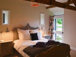a bedroom with a bed with white sheets and pillows at The Carriage House in Belsay