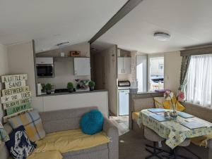 a living room with a couch and a table at Beachhome in Heacham