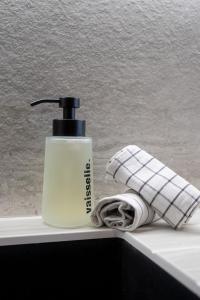 a bottle of soap and a towel on a counter at Appartement Cafetan in Tignes