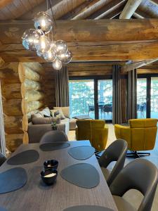 a living room with a table and yellow chairs at Chalet Deux B in Bad Kleinkirchheim