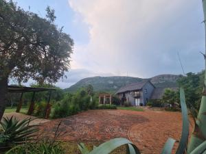 a view of a house with a mountain in the background at Mountain Villa House in Hartbeespoort