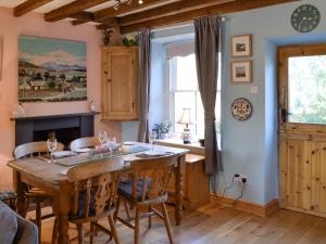 a dining room with a wooden table and chairs at Gwernol in Dolwyddelan