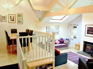 a living room with a table and a fireplace at Bank End in Glenridding