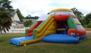 a colorful inflatable play structure in the grass at Royal Castel mobile home in Quimper