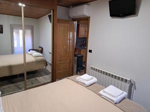 a bedroom with two beds and a mirror at Casa do sequeiro in Parada del Sil