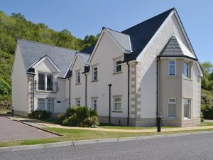 a white house with a black roof at Druimarbin Falls in Fort William