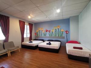 two beds in a room with flowers on the wall at THE ZULEY HERITAGE HOTEL in Kuala Perlis