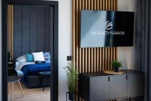Postel nebo postele na pokoji v ubytování Domki i apartamenty Skandynawia z basenem