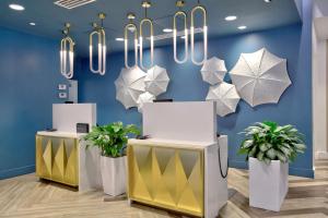 a room with blue walls and white and silver umbrellas at Hotel Indigo - New Orleans - French Quarter in New Orleans