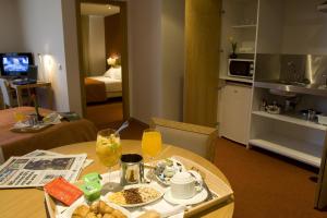 a room with a table with a tray of food at Paredes Hotel Apartamento in Paredes