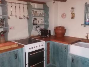 a kitchen with a stove and a sink at Cragg Cottage in Bouth