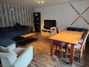uma sala de estar com uma mesa e um sofá em Ferienwohnung Finkeldei em Winterberg