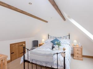 a bedroom with a bed in a attic at Drovers Cottage in East Meon