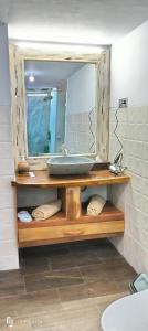 a bathroom with a sink and a mirror at Wage cottage in Nusa Penida