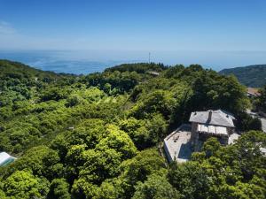 an aerial view of a building in the trees at A Dream Deferred villa Pelion in Kissós