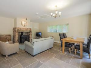a living room with a couch and a table and a fireplace at Stone Lodge in Fulbeck