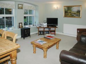 a living room with a couch and a coffee table at Chapelfield Cottage in Rosthwaite